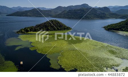 Aerial view of the beautiful landscape of Lake Skadar in the mountain on a sunny day. Montenegro Aerial view of the beautiful landscape of Lake Skadar in the mountain on a sunny day. Montenegro 44883872