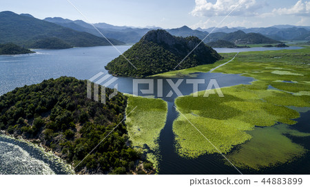Aerial view of the beautiful landscape of Lake Skadar in the mountain on a sunny day. Montenegro 44883899