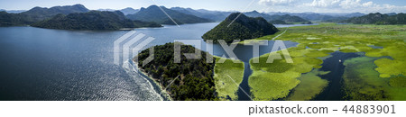 Aerial panoramic view of the beautiful landscape of Lake Skadar in the mountain on a sunny day Aerial panoramic view of the beautiful landscape of Lake Skadar in the mountain on a sunny day 44883901