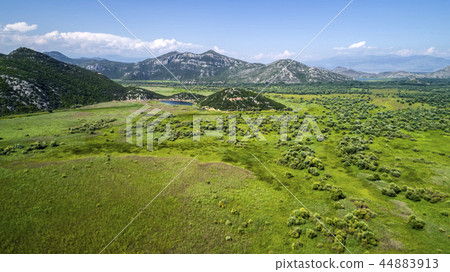 Aerial view of the landscape of Lake Skadar in the mountain and the island with monastery on a Aerial view of the landscape of Lake Skadar in the mountain and the island with monastery on a 44883913