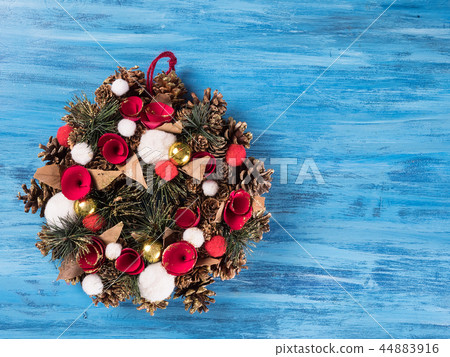 Chistmas door decoration with small gift boxes on blue wooden background 44883916