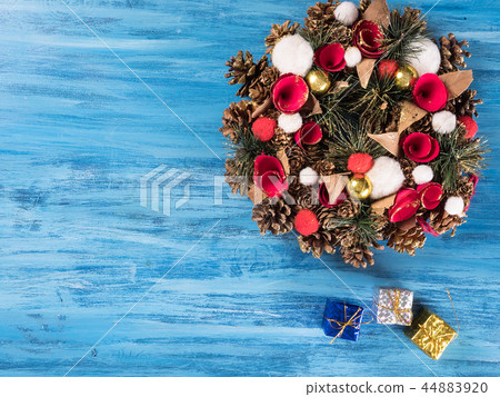 Chistmas door decoration with small gift boxes on blue wooden background Chistmas door decoration with small gift boxes on blue wooden background 44883920