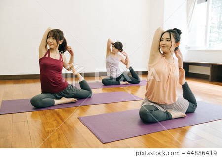 Young Japanese woman doing yoga pose of pigeon 44886419