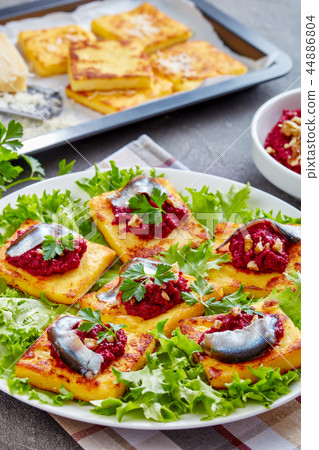 Polenta Squares with beetroot and anchovies 44886804