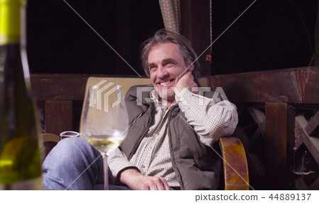 Senior man sitting in a chair on the terrace 44889137