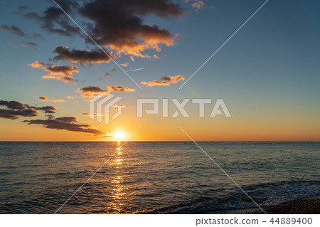Sunset on an empty sea beach. The end of the tourist season. Sunset on an empty sea beach. The end of the tourist season. 44889400