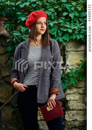 Posing with red handbag. Posing with red handbag. 44890132