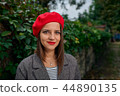 Calm smile and red beret. 44890135