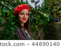 Girl hiding in leaves. 44890140