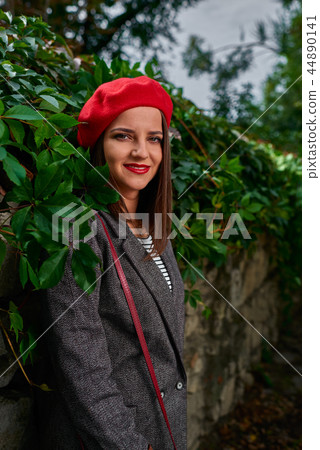 Lening on a fence. 44890141