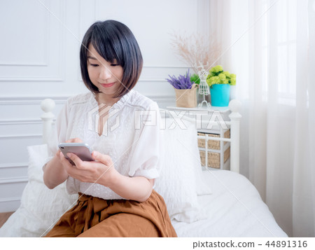 A woman using a smartphone 44891316