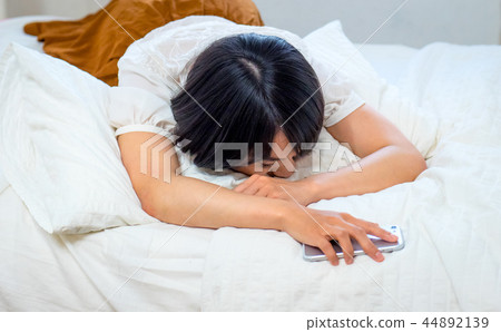A young woman sleeping in bed A young woman sleeping in bed 44892139
