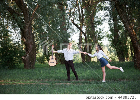 young couple walking in the forest and playing 44893723