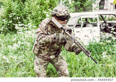 Military man with automatic rifle and rifle scope Military man with automatic rifle and rifle scope 44894497