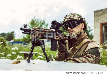 Military man with automatic rifle and rifle scope Military man with automatic rifle and rifle scope 44894499