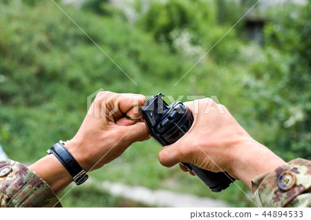 male hands holding a hand grenade for airsoft 44894533