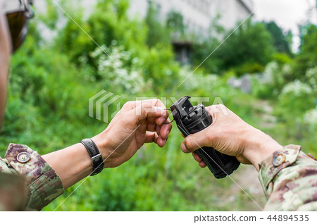male hands holding a hand grenade for airsoft male hands holding a hand grenade for airsoft 44894535