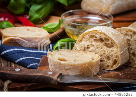 Sliced ciabatta bread on cutting board. Sliced ciabatta bread on cutting board. 44895282