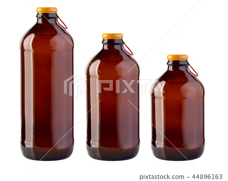 Brown glass beer bottle with yellow cap on white  44896163