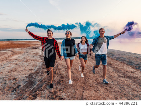 young friends running with hand flare or fusee young friends running with hand flare or fusee 44896221