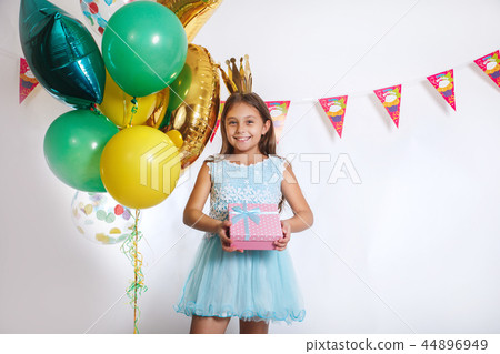 Portrait of a happy cute little kid holding gift box and looking at camera 44896949