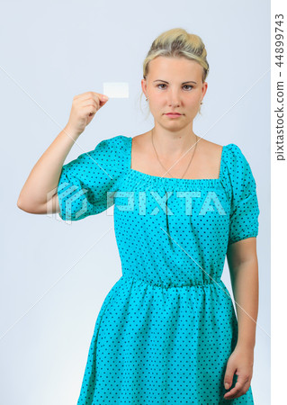 Young blonde girl holds business card 44899743