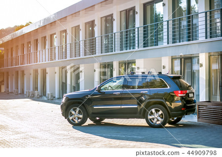 Black SUV parked in front of a new townhouse 44909798