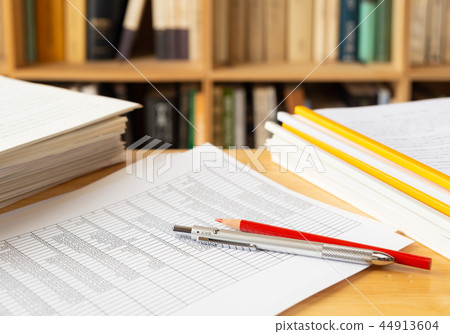 Spreadsheet bookshelf pile of materials report making research self development data statistics figures 44913604