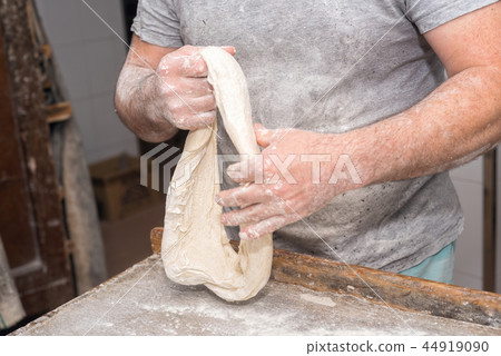 Baker hands kneading bread dough Baker hands kneading bread dough 44919090