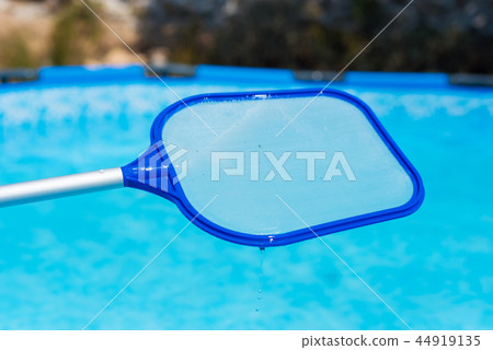 Backyard garden swimming pool cleaning close up Backyard garden swimming pool cleaning close up 44919135