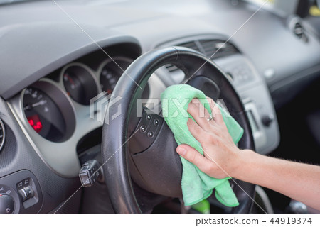 Young woman cleaning car interior Young woman cleaning car interior 44919374