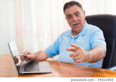 Cheerful senior man pointing his finger at you Cheerful senior man pointing his finger at you 44922068