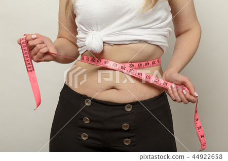 unrecognizable woman check her stomach fat unrecognizable woman check her stomach fat 44922658