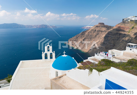 sunset over aegean sea with view to Virgin Mary Catholic Church Three Bells of Fira, Santorini. 44924355