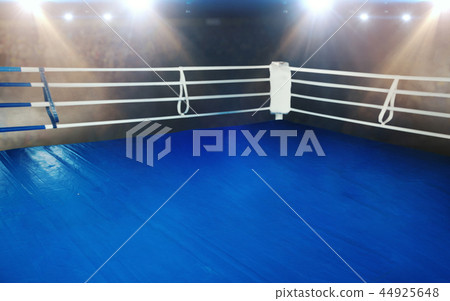 Boxing ring with blue flooring and white ropes Boxing ring with blue flooring and white ropes 44925648