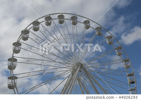 Part of a white ferris wheel on a blue sky  44926293