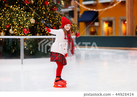 Kids ice skating in winter. Ice skates for child. Kids ice skating in winter. Ice skates for child. 44928414