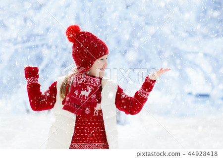 Child playing in snow on Christmas. Kids in winter Child playing in snow on Christmas. Kids in winter 44928418