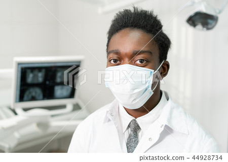 Young African American male doctor dentist in a medical mask. Medicine, health, stomatology concept 44928734
