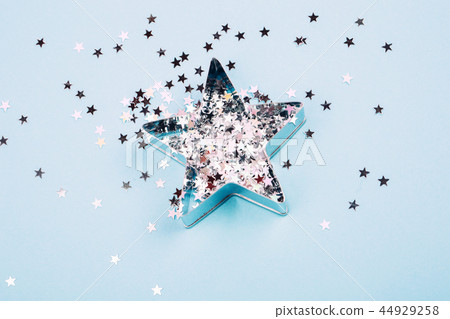 Star with sparkles on blue background 44929258