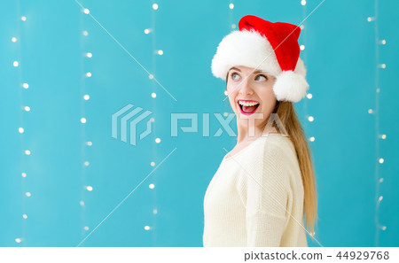 Happy woman with a Santa hat 44929768