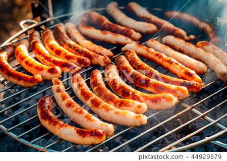 BBQ with fiery sausages on the grill 44929879