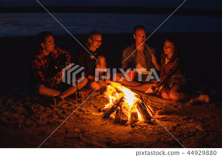 young friends have picnic with bonfire on the beach young friends have picnic with bonfire on the beach 44929880