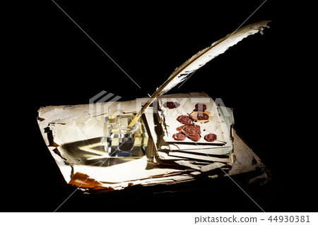 Old fountain pen, papers and inkwell on black 44930381