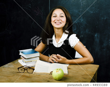 portrait of happy cute real teen student in classroom at blackbo 44933169