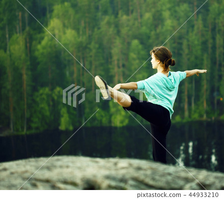 cute girl making gymnastic on the top of mountain 44933210