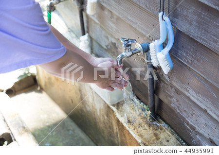 Young woman washing hands 44935991