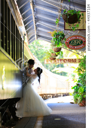 Wedding couple enjoying location photography with train in Kuranda station yard 44937184