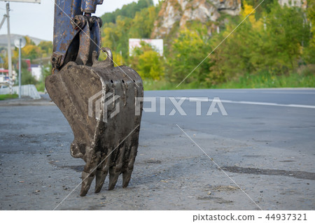 bucket excavator is near the road bucket excavator is near the road 44937321