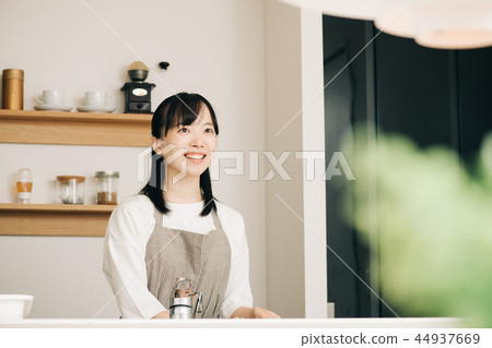 Young housewife standing in the kitchen Japanese woman Young housewife standing in the kitchen Japanese woman 44937669